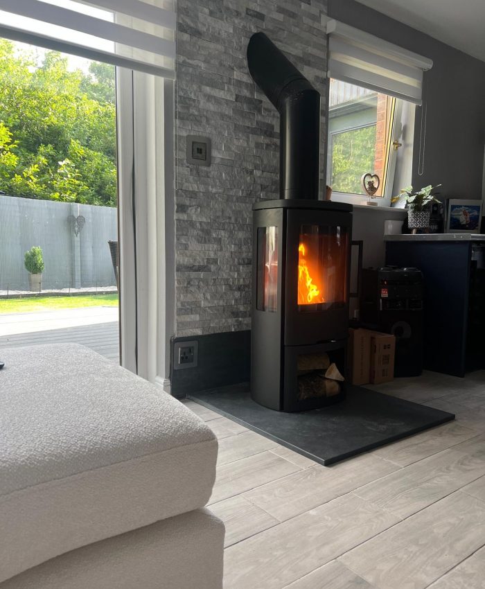 Termatech TT44G wood-burning stove installed with a Brazilian slate hearth and natural riven slate feature wall.